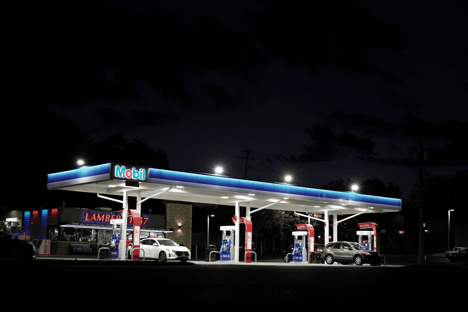 Gas station canopy and fueling area illuminated at night