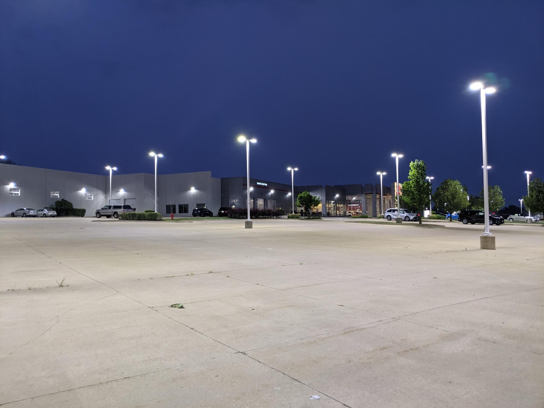 Commercial parking lot with pole-mounted LED lighting at night